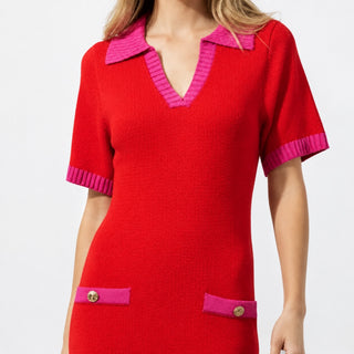 Close-up of the red knit sweater midi dress with hot pink ribbed trim and gold button pocket accents