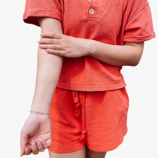 Person wearing a sticky nip cover on arm to show caramel color