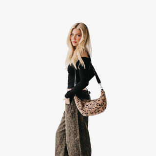 Leopard sherpa crossbody bag with a soft texture, adjustable strap, and roomy interior—an easy, on-trend bag for everyday fall and winter outfits.