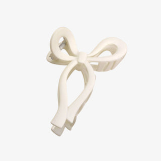 White bow-shaped hair clip on a white background
