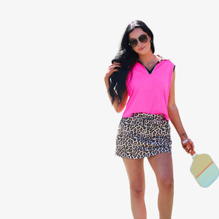 Women's leopard print performance skort with drawstring waist, gold-tone tips and side pockets, shown in a full front view.