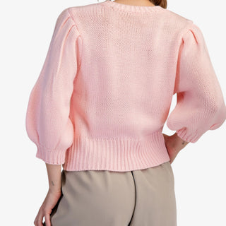 Blush puff sleeve button front sweater with ribbed hem styled with neutral shorts