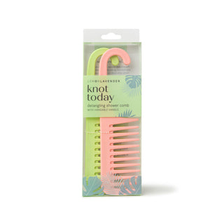 Pink comb with hanging handle in packaging on a white background