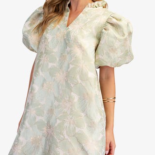 Sage floral puff sleeve mini dress with V-neckline and A-line fit on model wearing white flats