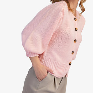 Blush puff sleeve button front sweater with ribbed hem styled with neutral shorts
