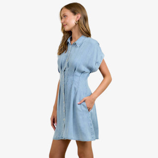 Light wash denim mini dress with button front, pleated waist, and short sleeves styled for casual everyday wear