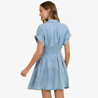 Light wash denim mini dress with button front, pleated waist, and short sleeves styled for casual everyday wear