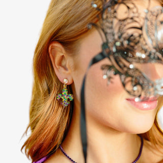 Carnival Confetti fleur-de-lis earrings with glitter-filled purple green and gold acrylic drop and iridescent crystal stud worn on model