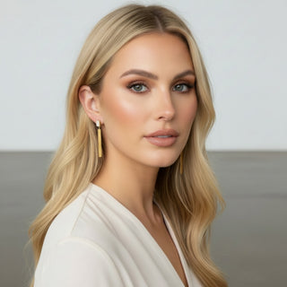 Woman wearing Everyday Gold Modern Drop Earrings with crystal rectangular studs and long brushed gold bar drops, modeled view