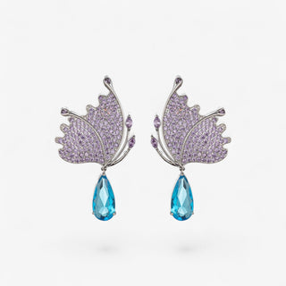 Eye Candy Los Angeles Millie teal butterfly dangle earrings with purple cubic zirconia and blue teardrop crystal, front product view.