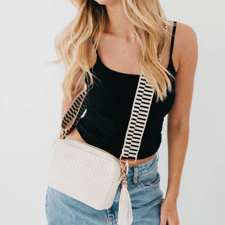 Model wearing the Pretty Simple Willow Crossbody Bag in Cream with striped strap and tassel detail