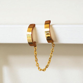 Double gold hoop earrings linked with a chain 