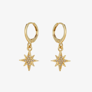 North Star gold earring set with pavé huggie hoops and interchangeable star, moon, and spike charms