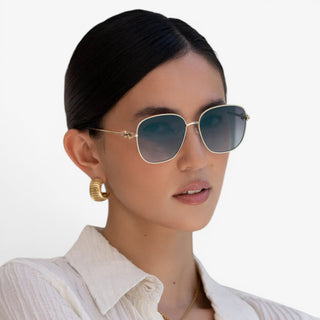 Gold frame sunglasses with gray gradient lenses on woman lifestyle view