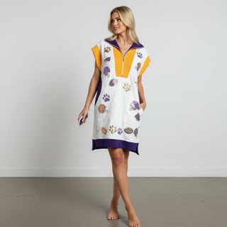 White Game Day sequin dress with purple and gold football embellishments worn while walking