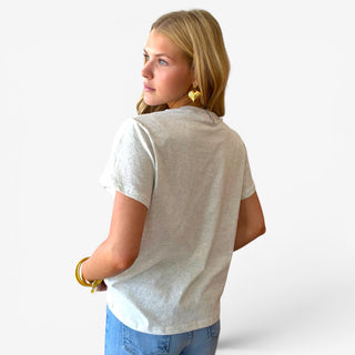 Back view of women’s heather cream tiger graphic tee showing the plain back, relaxed fit and short sleeves with blue jeans