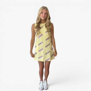 Butter yellow game day sequin dress with purple Geaux lettering, styled with white sneakers for a purple and gold tailgate, front view on model
