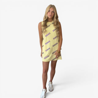 Yellow Geaux All Out sequin game day dress with purple lettering, styled with white sneakers in a full front view.