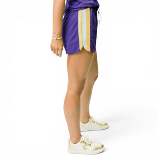 Women’s purple Geaux Tigers sequin shorts with gold and white sequin side stripes, side view, lightweight LSU game day athletic shorts.