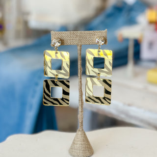 Gold mirrored tiger stripe double-square drop earrings with crystal studs displayed on a jewelry stand, front view for LSU game day.