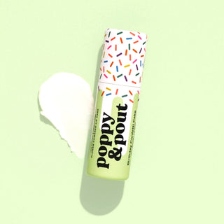Poppy & Pout Birthday Confetti Cake natural lip balm on a soft green background with balm swatch and sprinkle-print tube packaging.