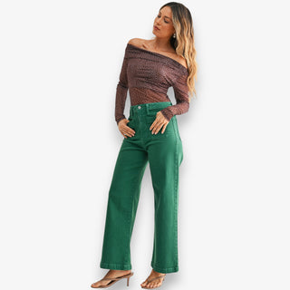 Green high-rise wide leg jeans with structured denim and full-length fit styled with heels on white background