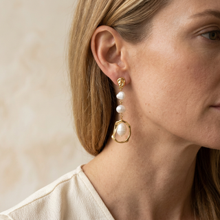 Alexa Pearl Drop Earrings shown worn beside the jaw.