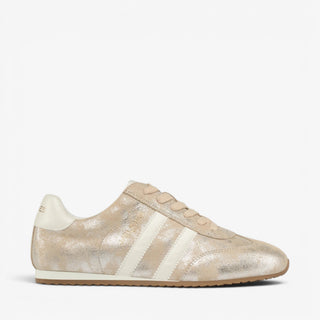 J/Slides Peggy metallic gold women’s sneaker with cream stripes and low-profile gum sole, shown from the side.