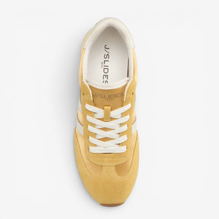 J/Slides Peggy yellow suede sneaker showing white laces, cushioned lining and low-profile shape from above