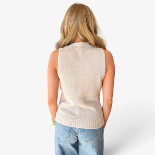 Khaki button front sweater vest for women showing the smooth knit back, sleeveless silhouette, and wide ribbed hem, back view with blue jeans.