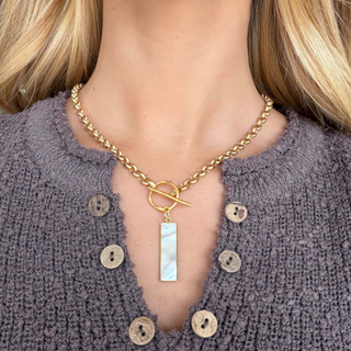 Kitzi Mother of Pearl Bar Necklace with gold-tone chain, toggle closure and rectangular mother of pearl pendant, worn close-up view