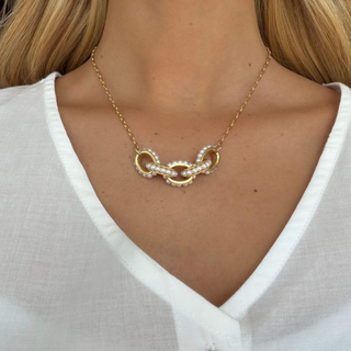Kitzi Perry Gold Pearl Necklace with delicate gold chain and interlocking gold links accented with pearls, shown worn in a close-up front view