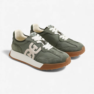 Green sneakers with brown soles on a white background