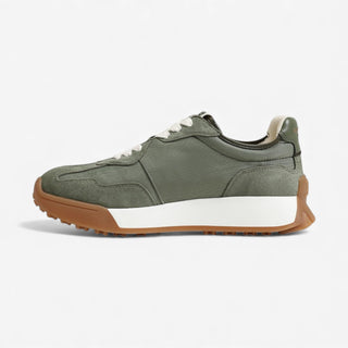 Green sneaker with brown sole on a white background