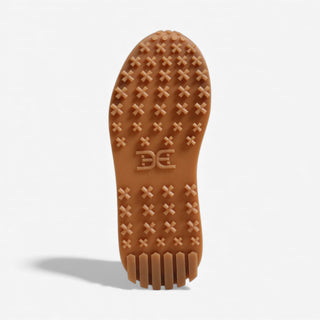 Brown sole of a shoe with tread pattern and brand logo on a light gray background