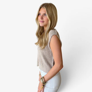 Oat Marlow button knit top with sleeveless shoulders, textured knit fabric and relaxed silhouette, side view.