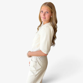 Melissa Nepton Lilo cream faux leather jacket on model, side view showing cropped fit and elbow-length sleeves