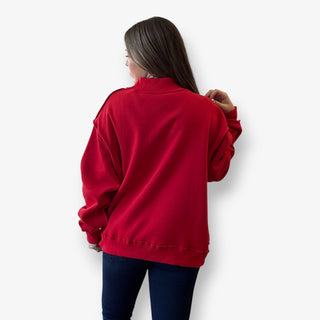 Person wearing a red sweatshirt against a white background