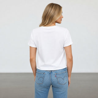 Michael Stars Jackie Tee White short sleeve crew neck T-shirt with waist-length hem styled with light wash jeans, back view
