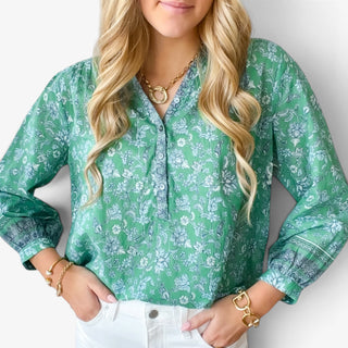     Michael Stars Katarina green floral printed popover top close-up showing the button neckline and contrasting border-print cuffs.