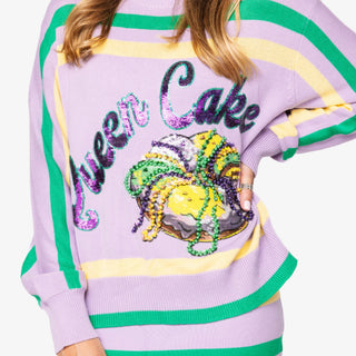 Queen of Sparkles lilac Queen Cake striped Mardi Gras sweater with sequin graphic and green and yellow trim.