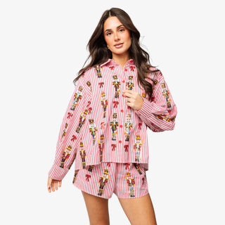 Model wearing Queen of Sparkles Nutcracker & Bow Button Up Top with red and white stripes and sequin nutcracker details