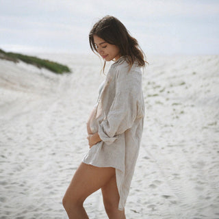 Oversized oatmeal linen button down shirt side profile beach lifestyle view