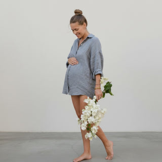 Slate blue linen button down shirt with oversized fit and floral detail standing view
