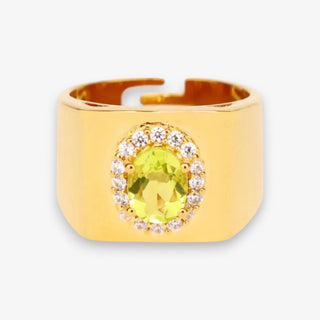 Gold ring with a yellow gemstone and small diamonds on a white background