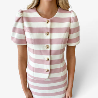 Pink and ivory striped skirt set featuring a fitted gold button-front top, round neckline and short puff sleeves, front close-up view.