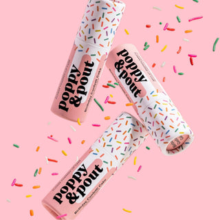 Poppy & Pout Birthday Confetti Cake lip balm trio with colorful sprinkles on a pink background showcasing playful sprinkle-inspired packaging.
