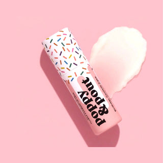 Poppy & Pout Birthday Confetti Cake lip balm on a pink background with hydrating balm swatch and colorful sprinkle-pattern tube.