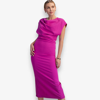 Woman wearing a bright pink dress against a white background