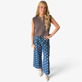 Blue polka dot denim pants with wide leg silhouette, white dot print, drawstring waist and patch pockets, front view